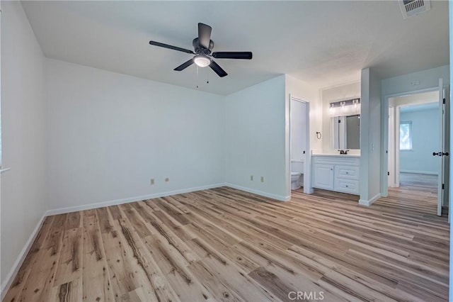 2950 Marie Ln, Merced, CA 95340 - unfurnished bedroom featuring light wood-style flooring, connected bathroom, and a ceiling fan