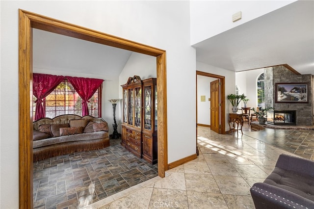 981 Deep Springs Dr, Claremont, CA 91711 - living room with stone tile flooring, a multi sided fireplace, and high vaulted ceiling