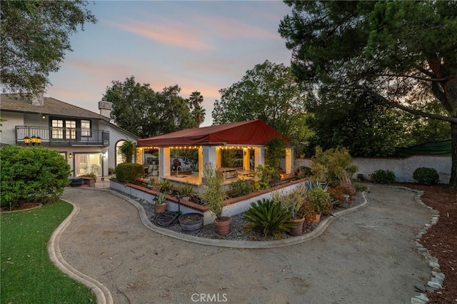 981 Deep Springs Dr, Claremont, CA 91711 - back of property at dusk featuring a balcony and a patio