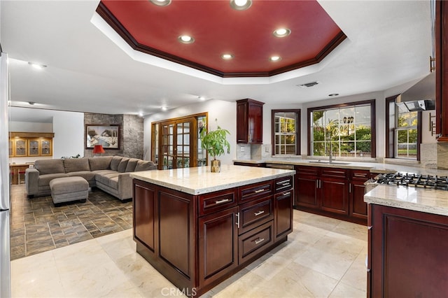 981 Deep Springs Dr, Claremont, CA 91711 - kitchen featuring reddish brown cabinets, a tray ceiling, recessed lighting, light stone countertops, and wall chimney range hood
