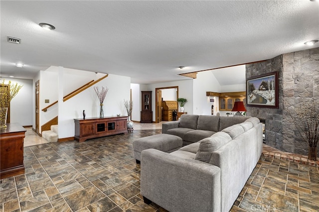 981 Deep Springs Dr, Claremont, CA 91711 - living area featuring a textured ceiling, stairs, and dark stone finish floors