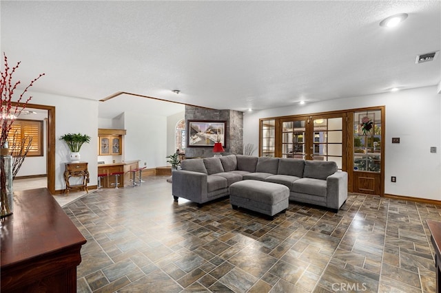 981 Deep Springs Dr, Claremont, CA 91711 - living area featuring a textured ceiling, stone finish flooring, and healthy amount of natural light