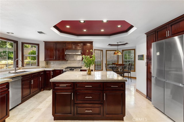 981 Deep Springs Dr, Claremont, CA 91711 - kitchen featuring appliances with stainless steel finishes, a raised ceiling, under cabinet range hood, a center island, and recessed lighting