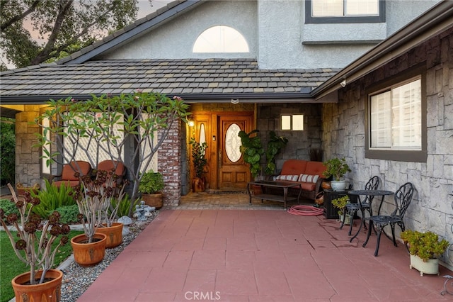 981 Deep Springs Dr, Claremont, CA 91711 - doorway to property featuring stucco siding, stone siding, and a patio area