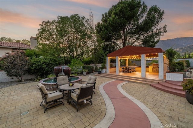 981 Deep Springs Dr, Claremont, CA 91711 - view of patio featuring a hot tub, outdoor dining area, and a mountain view