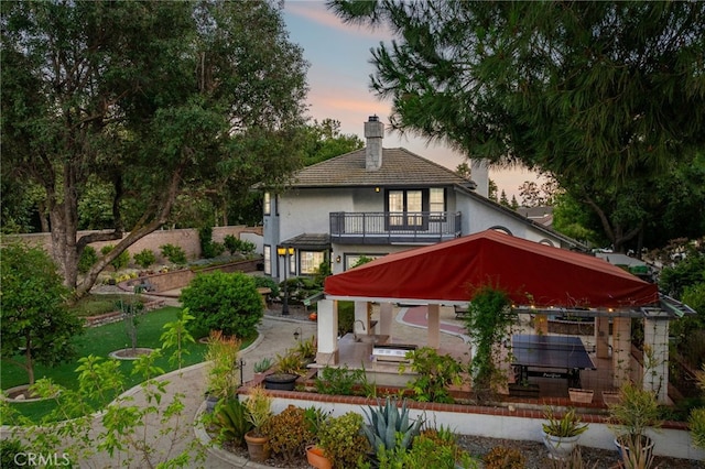 981 Deep Springs Dr, Claremont, CA 91711 - back of property featuring a balcony, a chimney, and stucco siding
