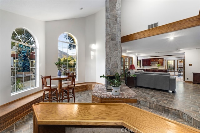 981 Deep Springs Dr, Claremont, CA 91711 - dining area featuring stone tile flooring and a high ceiling