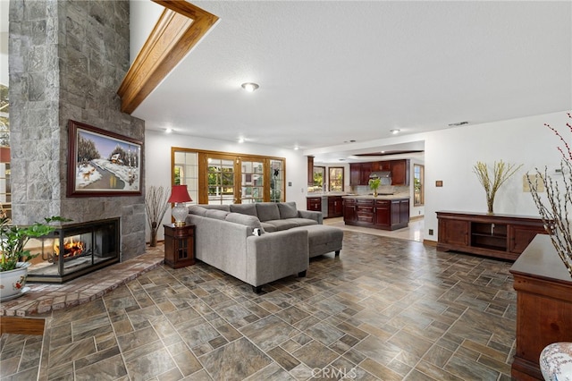 981 Deep Springs Dr, Claremont, CA 91711 - living room featuring a multi sided fireplace and stone finish floors