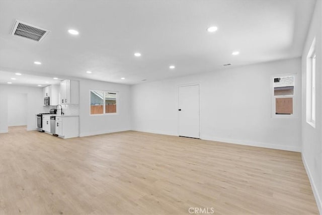 25415 Paloma Rd, San Bernardino, CA 92410 - unfurnished living room with light wood-style floors and recessed lighting
