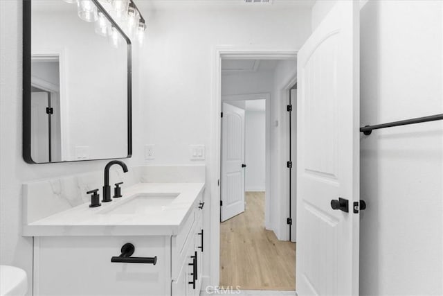 25415 Paloma Rd, San Bernardino, CA 92410 - bathroom with vanity and wood finished floors