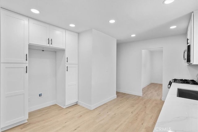 25415 Paloma Rd, San Bernardino, CA 92410 - kitchen featuring light wood-type flooring, white cabinets, recessed lighting, stainless steel microwave, and light stone counters