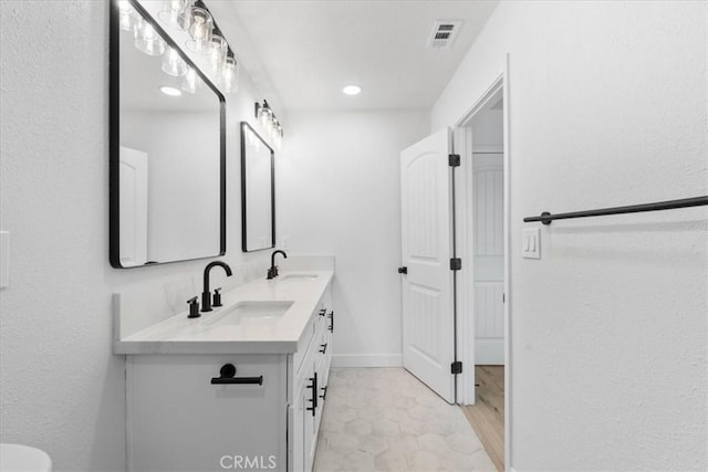 25415 Paloma Rd, San Bernardino, CA 92410 - bathroom featuring double vanity and recessed lighting