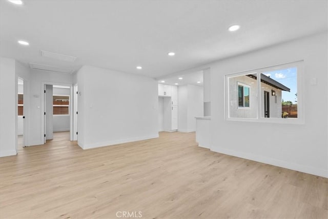 25415 Paloma Rd, San Bernardino, CA 92410 - unfurnished living room featuring light wood-style flooring, attic access, and recessed lighting