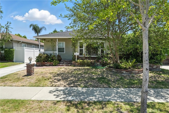 4752 Josie Ave, Lakewood, CA 90713 - view of front of home featuring stucco siding, covered porch, and concrete driveway