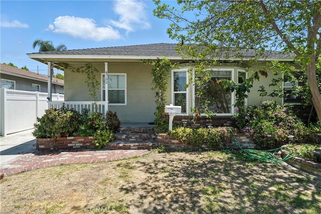 4752 Josie Ave, Lakewood, CA 90713 - view of front of property featuring a porch, stucco siding, and a shingled roof