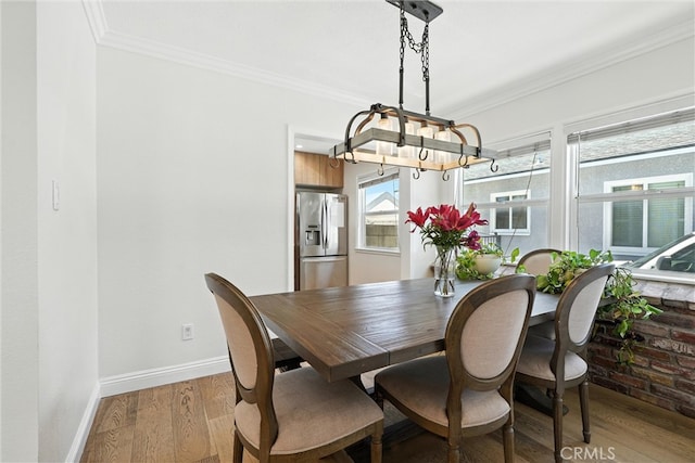 4752 Josie Ave, Lakewood, CA 90713 - dining space with a chandelier, light wood-style flooring, and ornamental molding