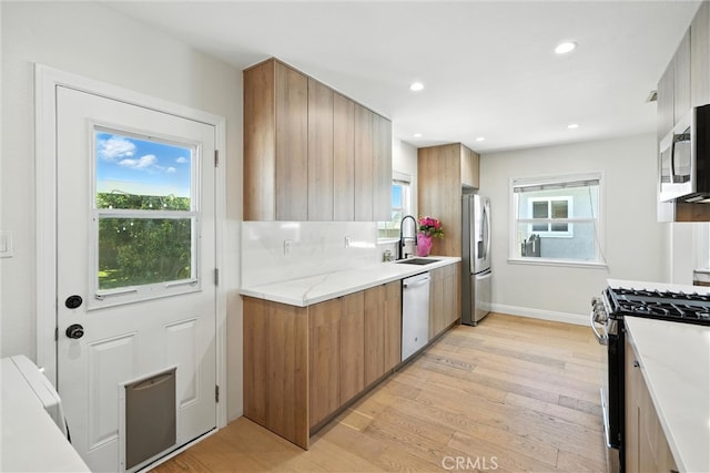 4752 Josie Ave, Lakewood, CA 90713 - kitchen featuring stainless steel appliances, light wood-type flooring, modern cabinets, and recessed lighting