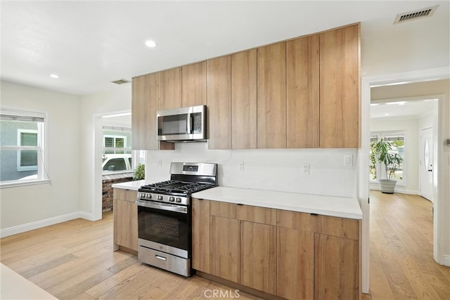 4752 Josie Ave, Lakewood, CA 90713 - kitchen featuring stainless steel appliances, light wood-style floors, light countertops, and recessed lighting