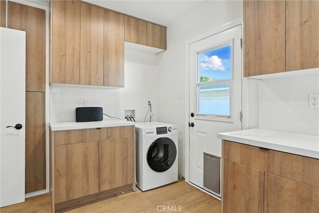 4752 Josie Ave, Lakewood, CA 90713 - washroom with washer / dryer, cabinet space, and light wood-style flooring