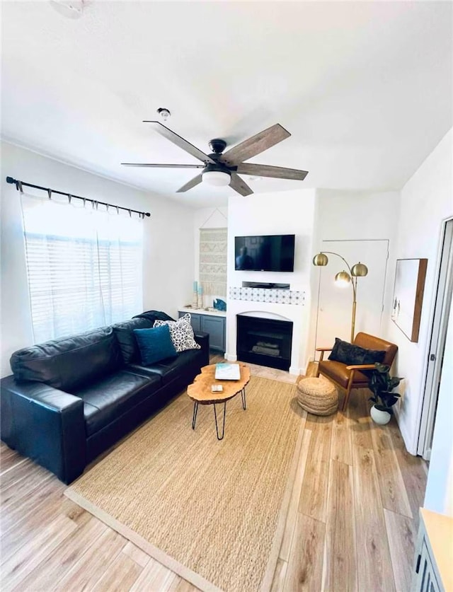 444 Pier Ave Unit 4, Oceano, CA 93445 - living room with light wood finished floors, a ceiling fan, and a fireplace with flush hearth