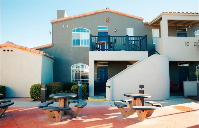 444 Pier Ave Unit 4, Oceano, CA 93445 - rear view of property with a balcony, stucco siding, and a tiled roof