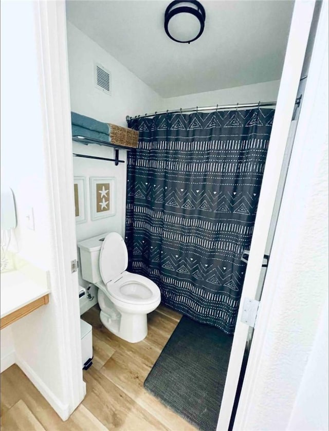 444 Pier Ave Unit 4, Oceano, CA 93445 - full bathroom featuring wood finished floors and curtained shower