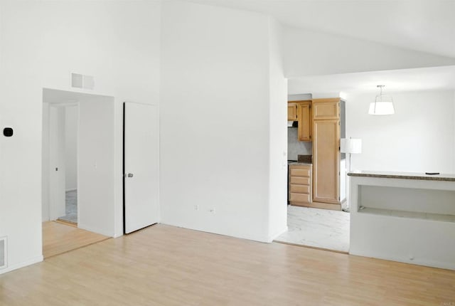 1817 E Grand Ave Unit 6, Escondido, CA 92027 - unfurnished living room featuring light wood-style flooring and high vaulted ceiling
