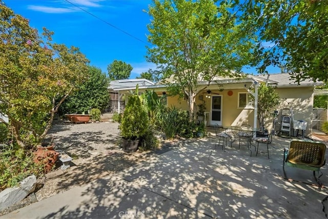13239 Sayre St, Sylmar, CA 91342 - back of house with ceiling fan, stucco siding, a patio, and outdoor dining space