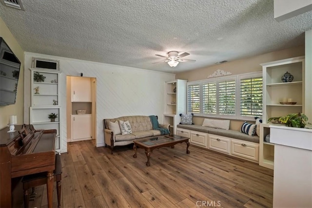 13239 Sayre St, Sylmar, CA 91342 - living room featuring a ceiling fan, a textured ceiling, and hardwood / wood-style flooring