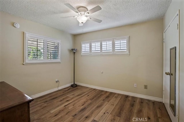 13239 Sayre St, Sylmar, CA 91342 - unfurnished bedroom featuring wood finished floors, a textured ceiling, and a ceiling fan