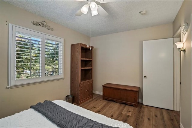 13239 Sayre St, Sylmar, CA 91342 - bedroom featuring wood finished floors, a textured ceiling, and ceiling fan