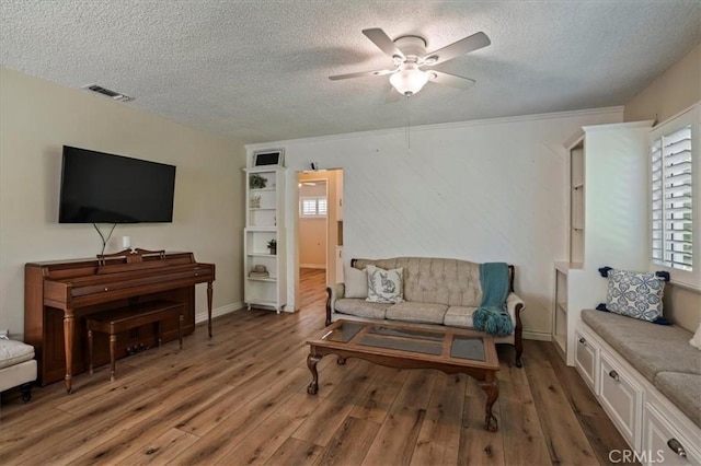 13239 Sayre St, Sylmar, CA 91342 - living room with a textured ceiling, light wood-type flooring, and a ceiling fan