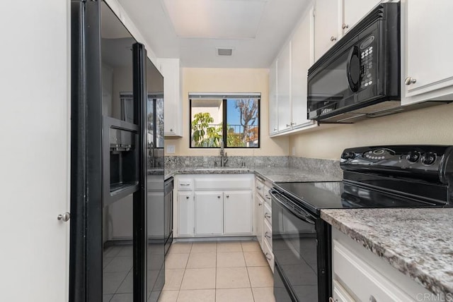 245 Fairlee Ln, Encinitas, CA 92024 - kitchen featuring black appliances, white cabinetry, light tile patterned floors, and light stone countertops