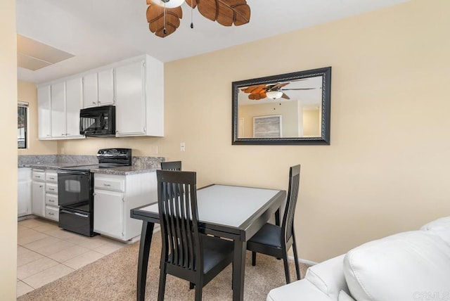 245 Fairlee Ln, Encinitas, CA 92024 - kitchen with black appliances, white cabinetry, ceiling fan, light tile patterned floors, and light countertops