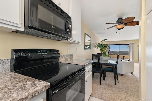 245 Fairlee Ln, Encinitas, CA 92024 - kitchen with black appliances, white cabinets, a ceiling fan, and light colored carpet