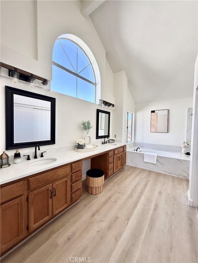 18 Decente, Irvine, CA 92614 - full bathroom featuring high vaulted ceiling, double vanity, a bath, wood finished floors, and plenty of natural light