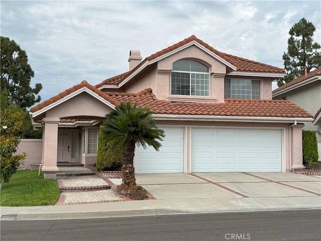 18 Decente, Irvine, CA 92614 - mediterranean / spanish house with a chimney, concrete driveway, a tiled roof, and stucco siding