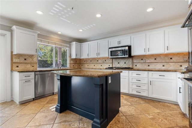 29 Hemingway Ct, Trabuco Canyon, CA 92679 - kitchen with appliances with stainless steel finishes, ornamental molding, white cabinets, dark stone countertops, and recessed lighting