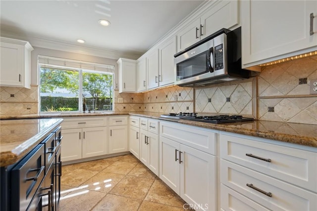 29 Hemingway Ct, Trabuco Canyon, CA 92679 - kitchen with stainless steel microwave, gas cooktop, ornamental molding, white cabinets, and recessed lighting