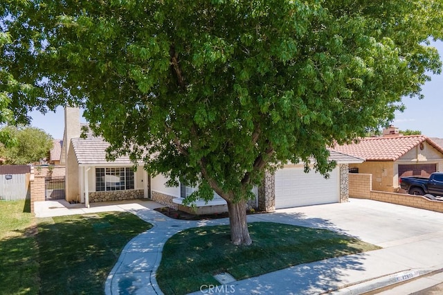 43920 Delgado Ct, Lancaster, CA 93535 - obstructed view of property featuring stone siding, driveway, and a tiled roof