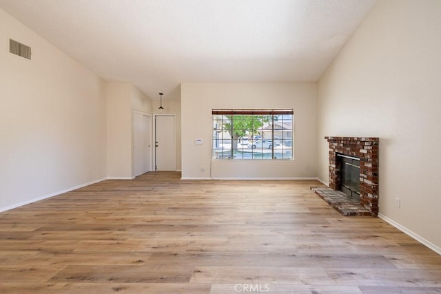 43920 Delgado Ct, Lancaster, CA 93535 - unfurnished living room with light wood-style floors and a brick fireplace