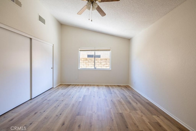 43920 Delgado Ct, Lancaster, CA 93535 - unfurnished bedroom with vaulted ceiling, wood finished floors, a textured ceiling, a closet, and ceiling fan