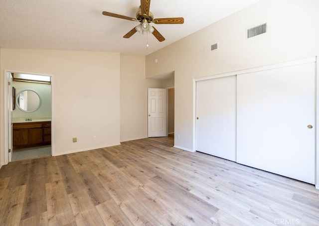 43920 Delgado Ct, Lancaster, CA 93535 - unfurnished bedroom with light wood-type flooring, a closet, ensuite bathroom, a towering ceiling, and a ceiling fan