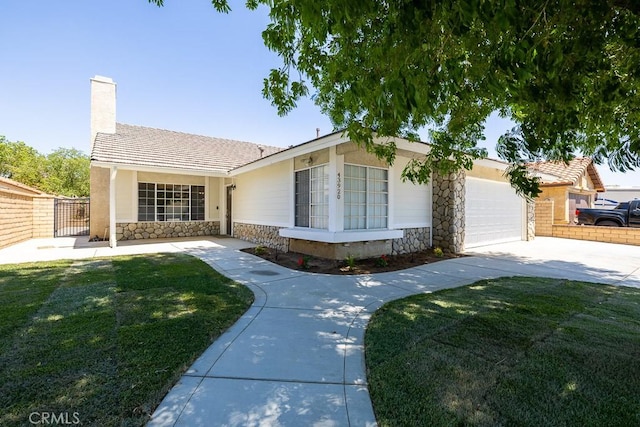 43920 Delgado Ct, Lancaster, CA 93535 - ranch-style home with stone siding, an attached garage, driveway, and a chimney