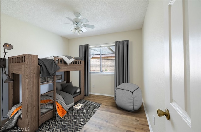 43920 Delgado Ct, Lancaster, CA 93535 - bedroom featuring wood finished floors, a textured ceiling, and a ceiling fan