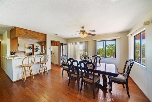 7575 Whitney Ave, Yucca Valley, CA 92284 - dining room with dark wood finished floors, ceiling fan, and a textured ceiling