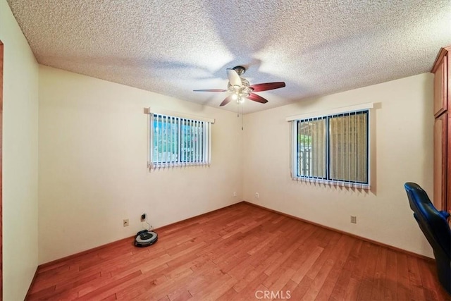 7575 Whitney Ave, Yucca Valley, CA 92284 - unfurnished room featuring ceiling fan, light wood-style flooring, and a textured ceiling