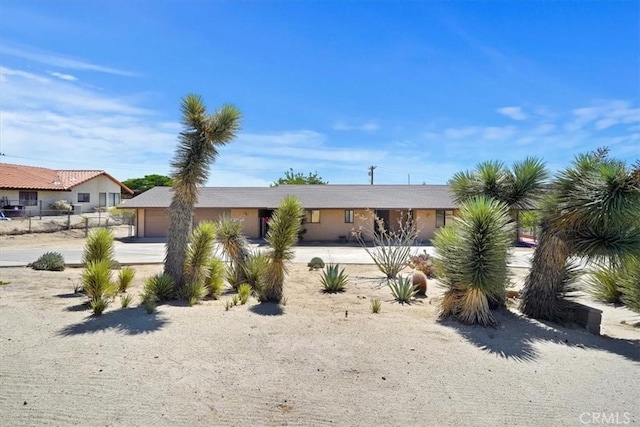 7575 Whitney Ave, Yucca Valley, CA 92284 - view of front of home featuring concrete driveway and a garage