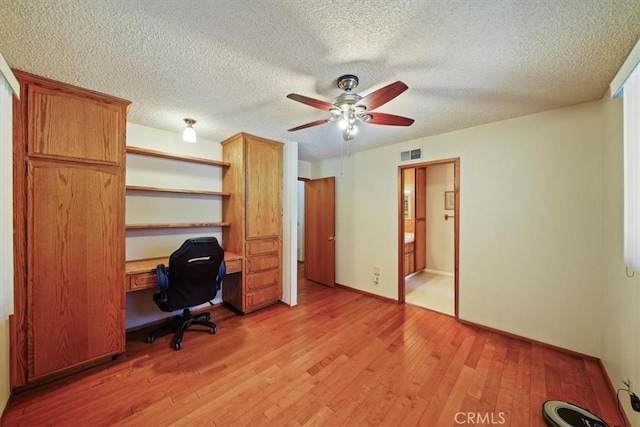 7575 Whitney Ave, Yucca Valley, CA 92284 - home office featuring a ceiling fan, light wood-style floors, and a textured ceiling