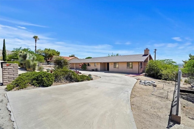 7575 Whitney Ave, Yucca Valley, CA 92284 - single story home with curved driveway and a chimney